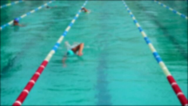 Swimming pool training. Athletes practice swimming technique. Out of focus. Slow motion.