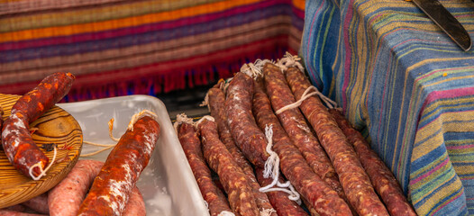 Typical Spanish sausages lying on a village stall at the food market