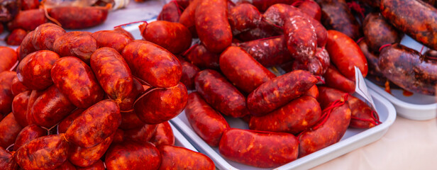 Typical Spanish sausages lying on a village stall at the food market