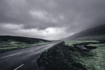 Misty mountain road through desolate landscape in Iceland