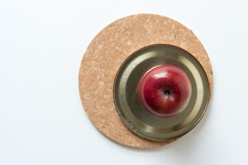 ripe crab apples on a metallic and cork background