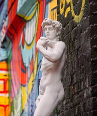 Oslo, Norway - 11.09.2015: Recreation of David statue against a graffitied background