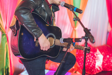 Fototapeta na wymiar Man's holding a guitar hands close up