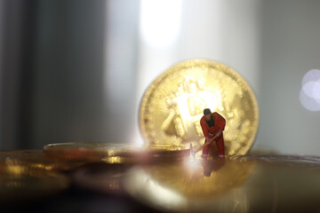 miniature people miner is digging on golden coin. Cryptocurrency bitcoin the future coin, Bitcoin...