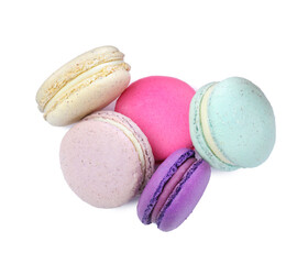 Different delicious colorful macarons on white background, top view