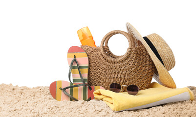 Stylish bag with beach accessories on sand against white background
