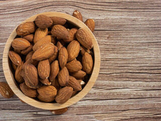 almond in wood bowl on wood table for food and health  concept