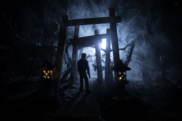 Creative artwork decoration. Abstract Japanese style wooden tunnel at night. Selective focus