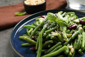 Plate of tasty salad with green beans on grey table, closeup
