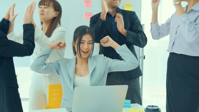 Business people celebrate success of proficiently finished project . Corporate business team collaboration concept .