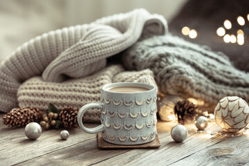 Fototapeta na wymiar Cozy winter composition with a cup and decor details.