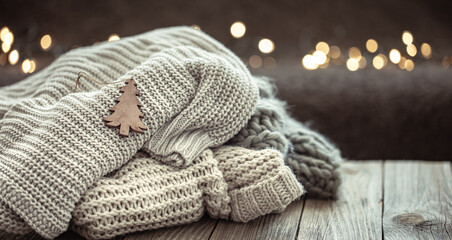 Winter festive background with knitted element on blurred background.