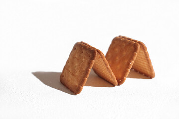 A close up shot of the delicious crispy crackers laid out in a shape of M letter on the white background