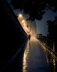 runner running along a bridge at night