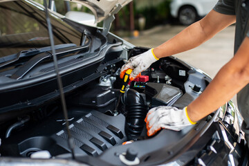 Fototapeta na wymiar Mechanic using screwdriver to inspect car