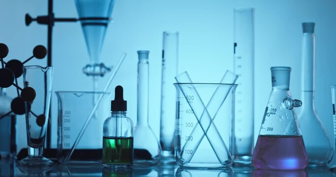 Hand scientist shaking Erlenmeyer flask with chemical liquid, Scientific equipment and science technology concept