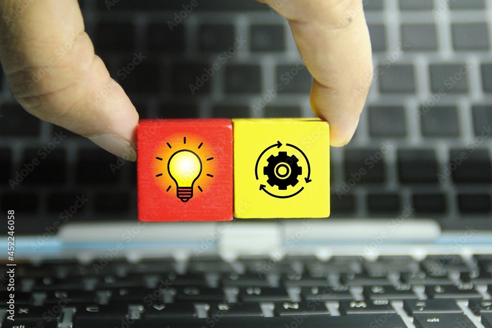 Poster hand holding colored cubes with icons of ideas and management. idea management concepts