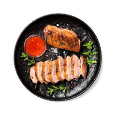 Roasted duck breast served with sauce and fresh herbs. Isolated on white background, top view