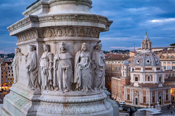 Fototapeta na wymiar The huge marble sculptured stone base of Victor Emmanuel II statue, as seen from the Altar of the Fatherland, with background of Santa Maria di Loreto church in piazza di Venezia in Rome, Italy 