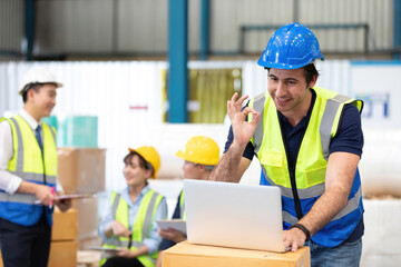 engineer or factory worker using laptop computer and showing OK gesture sign language to someone