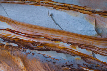 Textured sandstone rock. Contrasting orange and white. No people. Background.