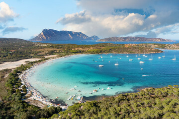 View from above, stunning aerial view of Cala Brandinchi beach with its beautiful white sand, and crystal clear turquoise water. Tavolara island in the distance, Sardinia, Italy.