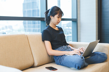 Asian young woman working with laptop from home, freelance work job.