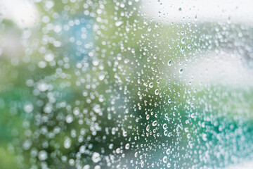 Rain drops on the surface of window with country background. autumn weather and meteorology concept