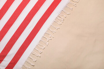 Striped beach towel on sand, top view. Space for text