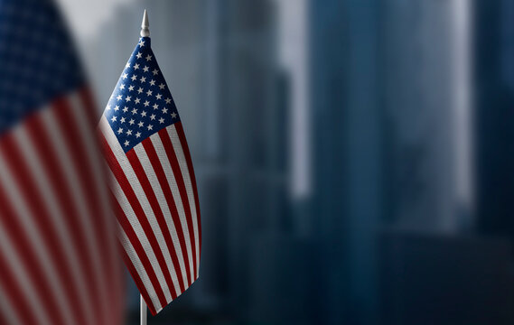 A small flag of United States on the background of a blurred background