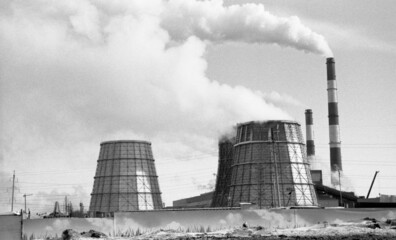 Clouds of smoke and vapor rise out of the co-generation unit funnels at dawn. Winter time.