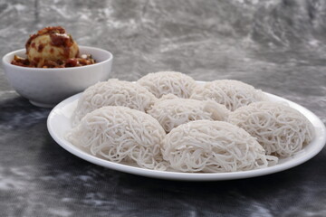 Idiyappam served with egg roast- Kerala food recipes background.