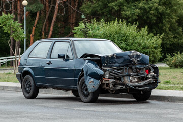 The car is parked after the accident, the hood is broken, the consequences of inattention on the...