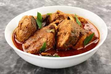 Homemade spicy Kerala fish curry cooked in gravy .