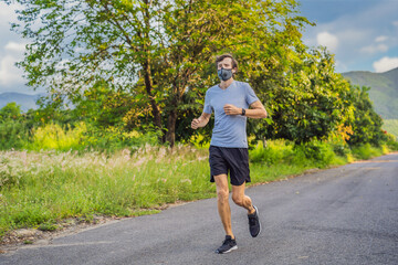 Fototapeta premium Runner wearing medical mask, Coronavirus pandemic Covid-19. Sport, Active life in quarantine surgical sterilizing face mask protection. Outdoor run on athletics track in Corona Outbreak
