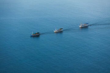 Three boats floating in the sea 