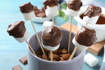 Delicious marshmallows covered with chocolate in cup, closeup