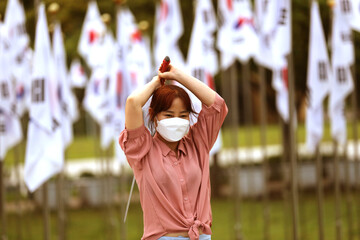 Korean woman practicing kendo in a hi-dong kendo pose with a sword