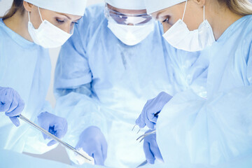 A group of surgeons is operating at the hospital. Health care concept