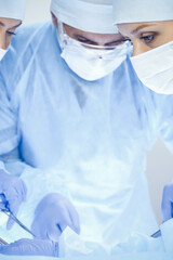 A group of surgeons is operating at the hospital. Health care concept