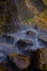 Clear water flows from a large waterfall in the very center of Sofievsky park