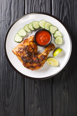 Ayam Bakar is a dish of charcoal-grilled chicken marinated in kecap manis, coconut oil, shallot, garlic, chilli pepper, coriander, tamarind juice, candlenut, turmeric and galangal Vertical top view