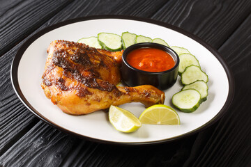Ayam Bakar Indonesian Grilled Chicken closeup in the plate on the table. Horizontal