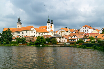 Fototapeta na wymiar View of Telc city Panorama with cloudy sky seen from the surrounding river. The historic center of Telc in southern Moravia, Czech Republic, is a UNESCO World Heritage Site.
