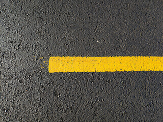 Fototapeta premium the yellow line on asphalt, yellow road texture background
