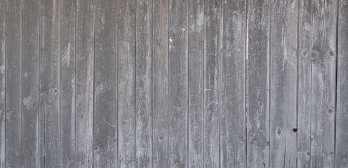 Old gray wooden background, planks arranged vertically. Grunge texture.