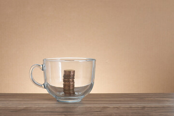 Coins stacked in the transparent glass cup