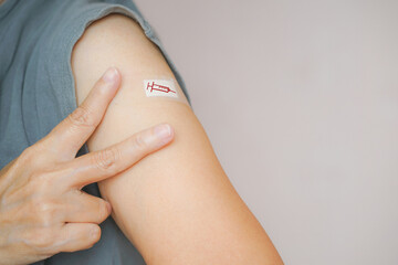 senior woman show two fingers, victory sign, after vaccinated or inoculation due to spread of corona virus, population, social or herd immunity ,immunization vaccine health concept