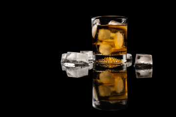 Glass of drink with ice  on reflected balck surface isolated