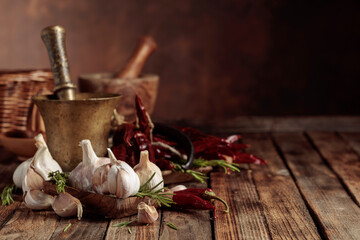 Fresh garlic bulbs with rosemary and red pepper.